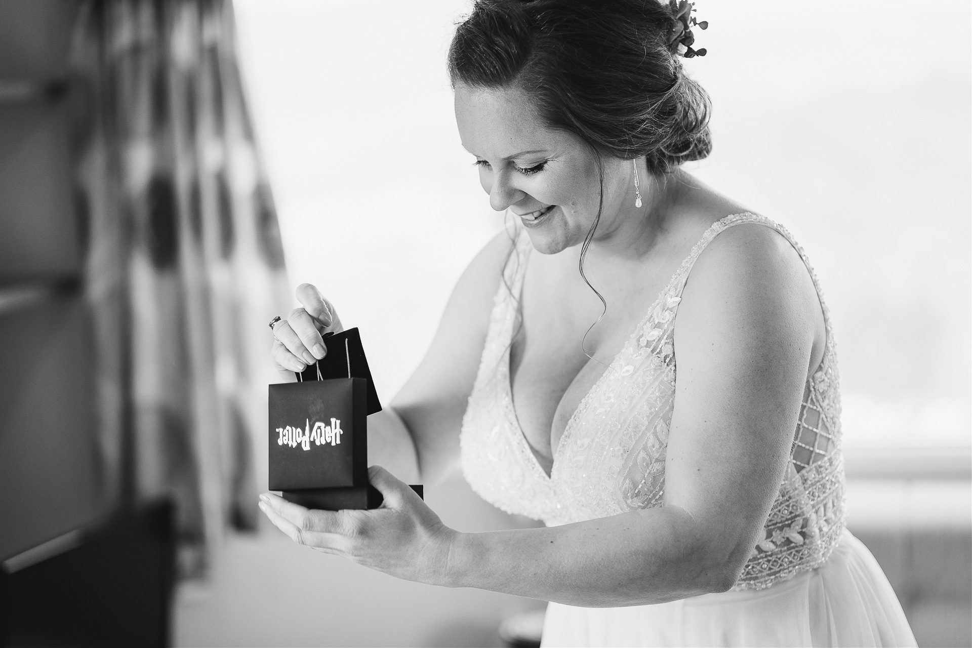 Smiling bride opening a jewellery box