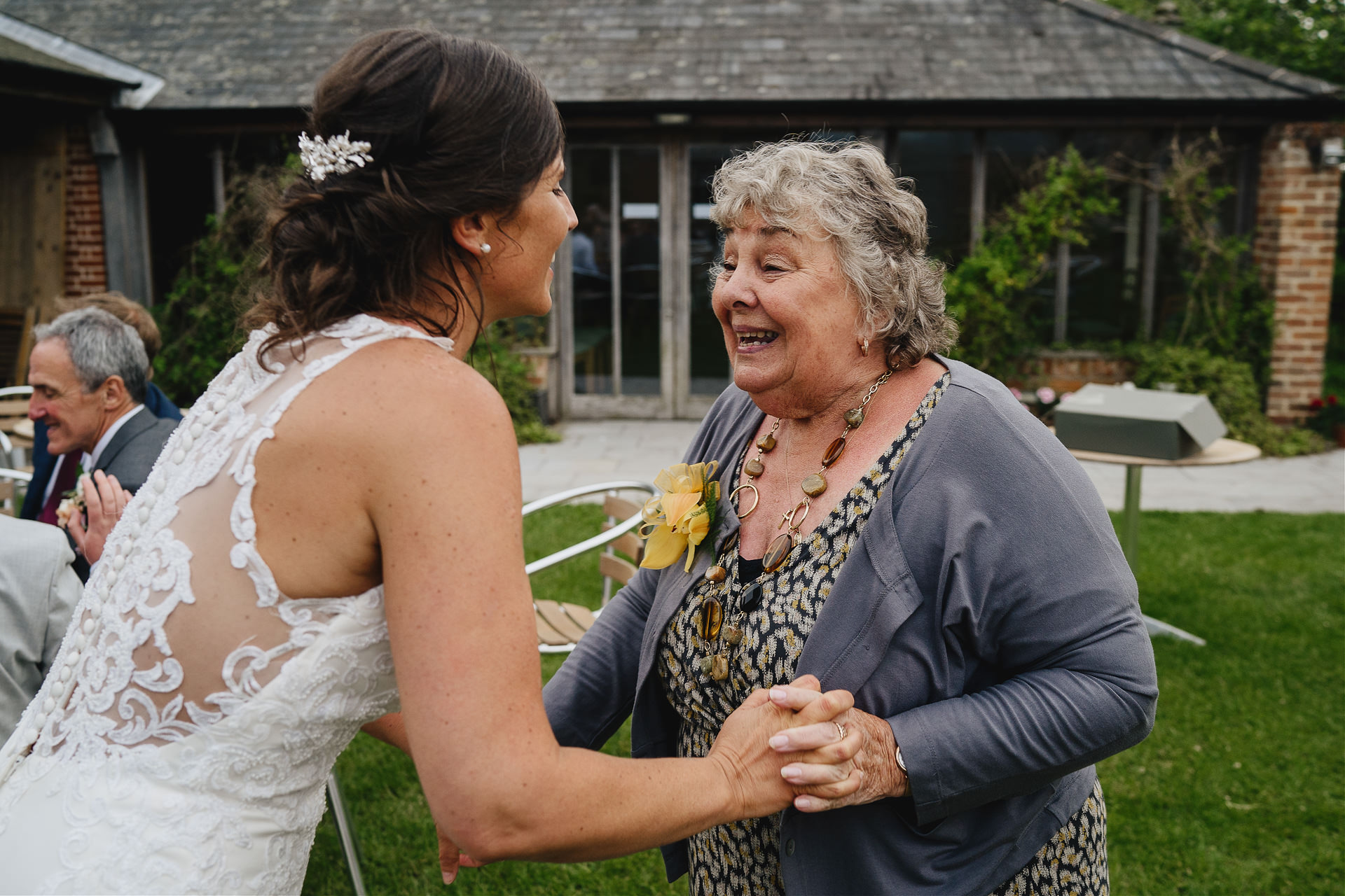Bride dancing with her grandma in the gardens at Cadhay