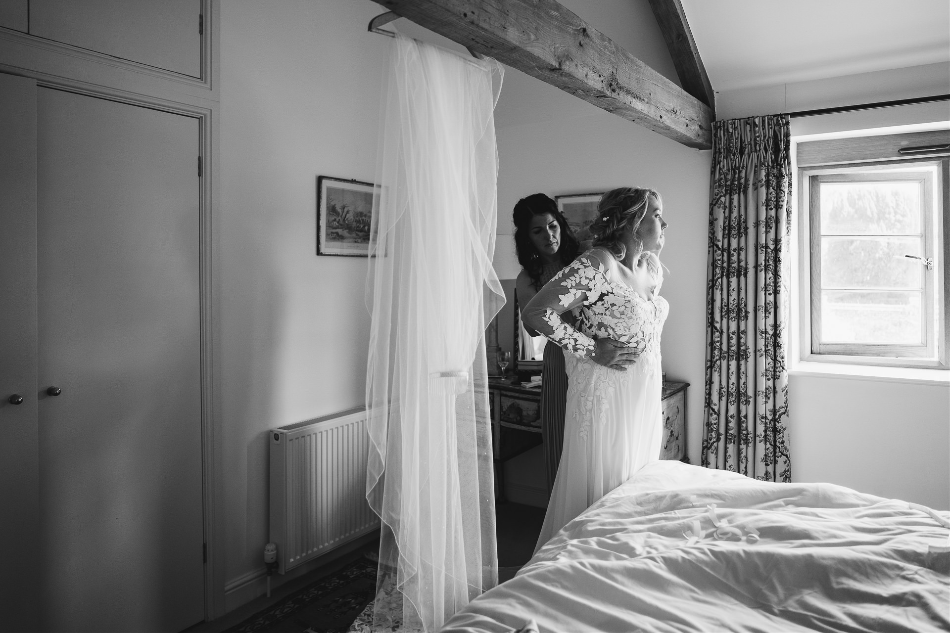 Bride getting into her wedding dress ready for her Cadhay wedding ceremony
