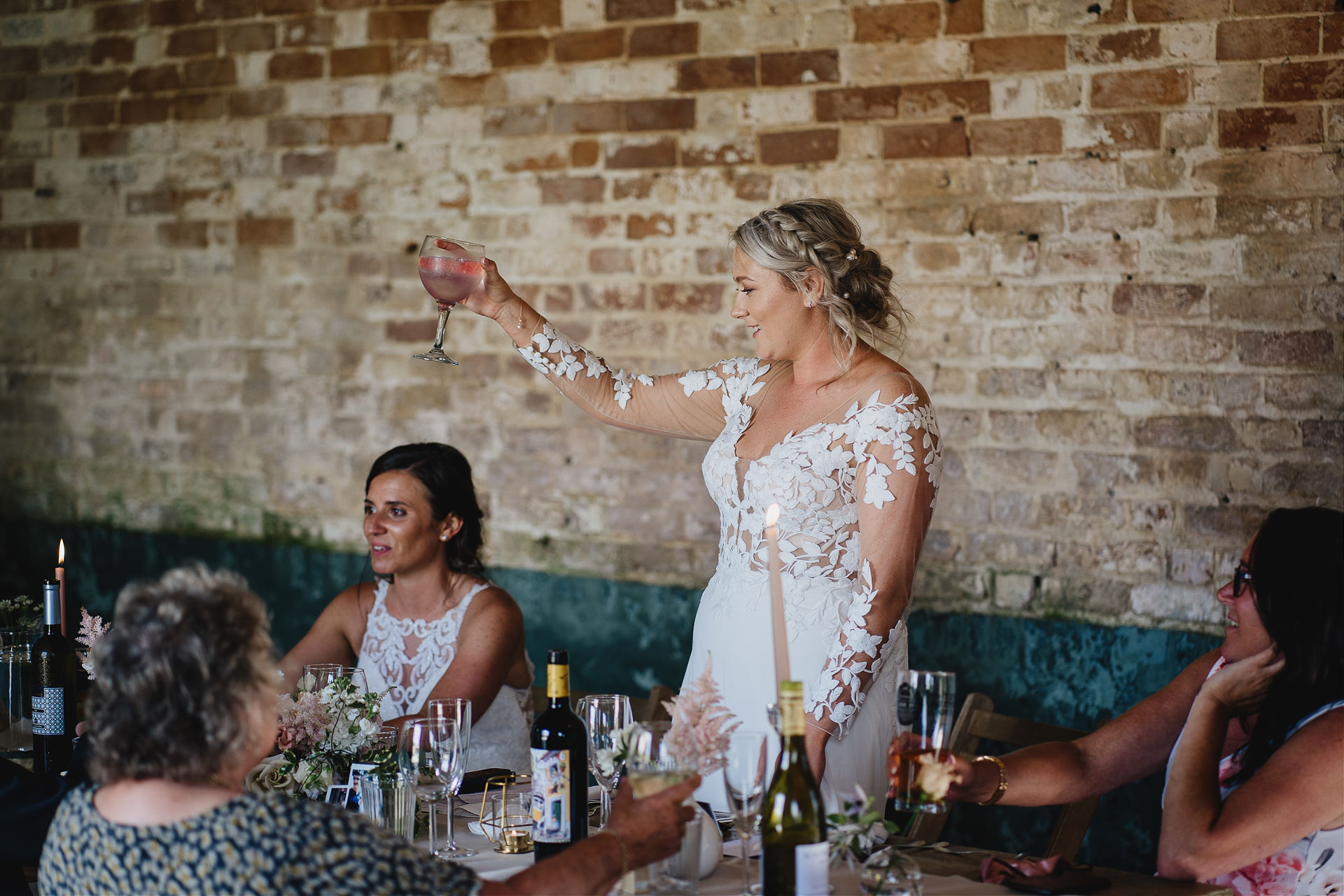 Bride toasting her wife during wedding speeches