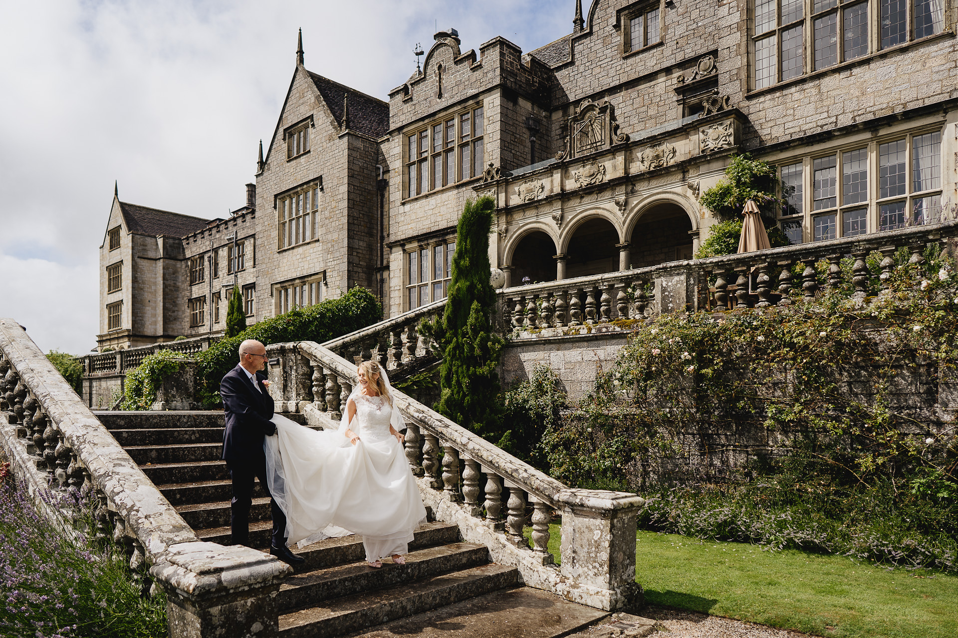Bride and groom walking down outside steps after a wedding at Bovey Castle