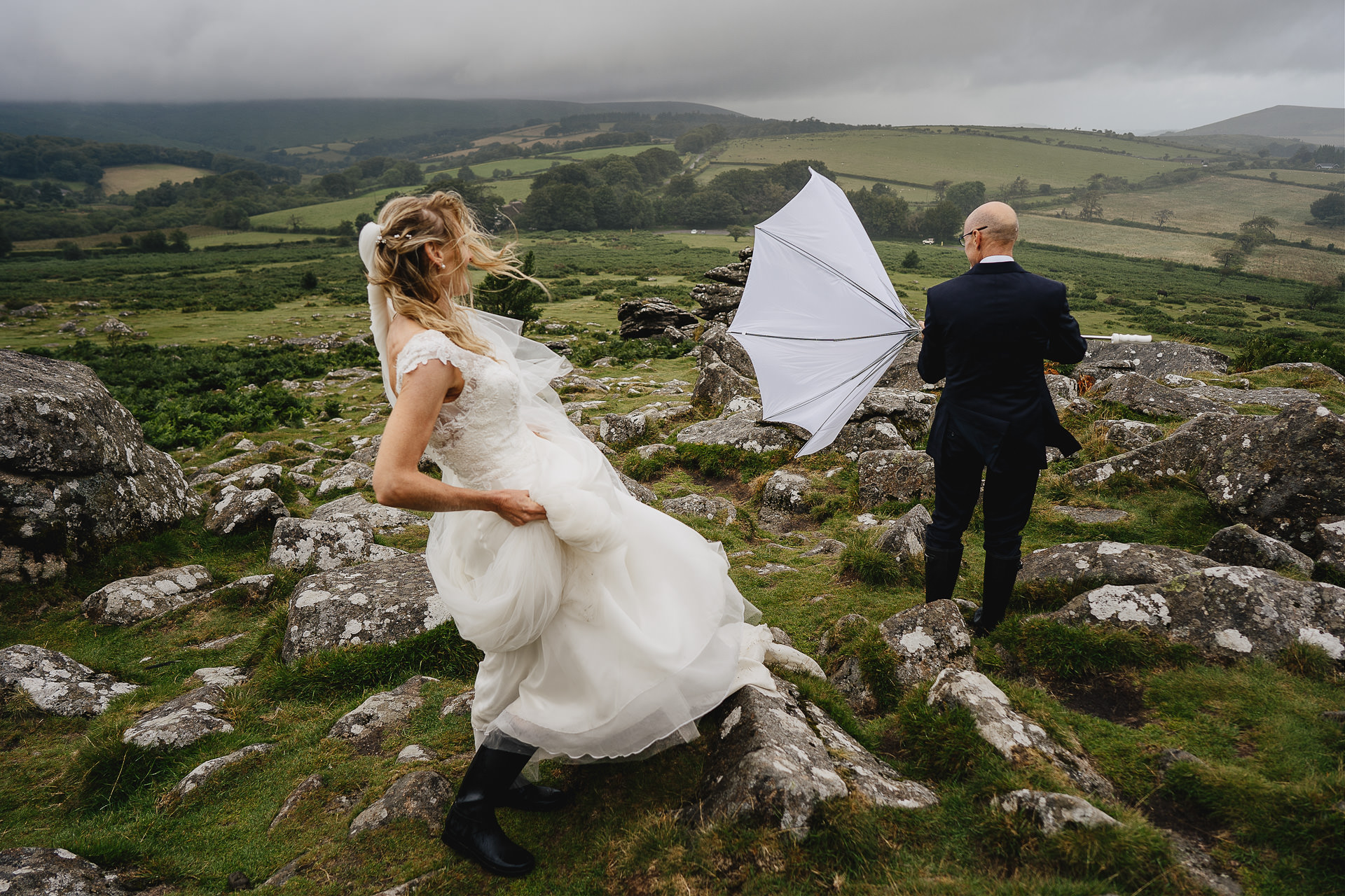 A bride and groom in high winds and rain on Dartmoor