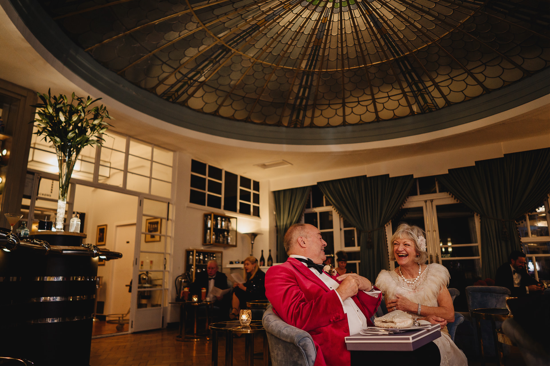 Bride and groom laughing together in the bar at their Burgh Island elopement