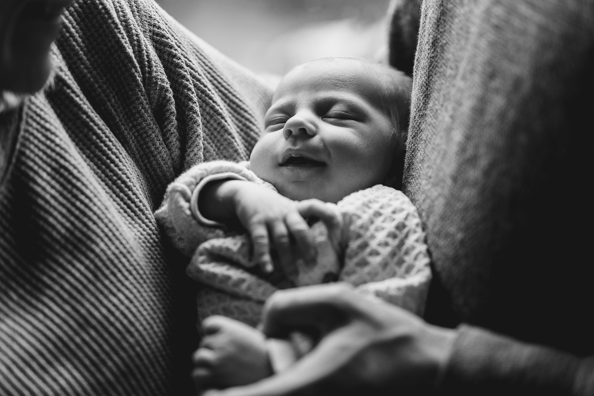 Family photography session with a baby cuddled between two parents