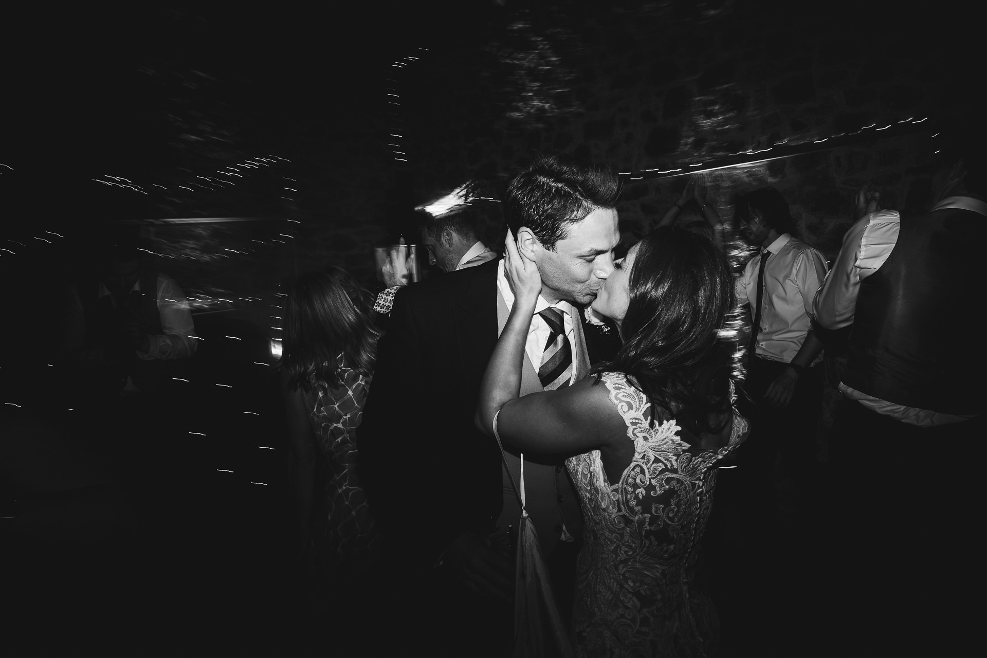 Bride and groom kissing on the dance floor at a wow factor barn wedding