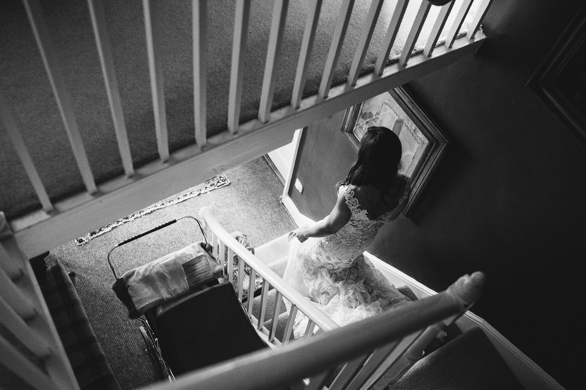 Bride in a wedding dress walking down a staircase