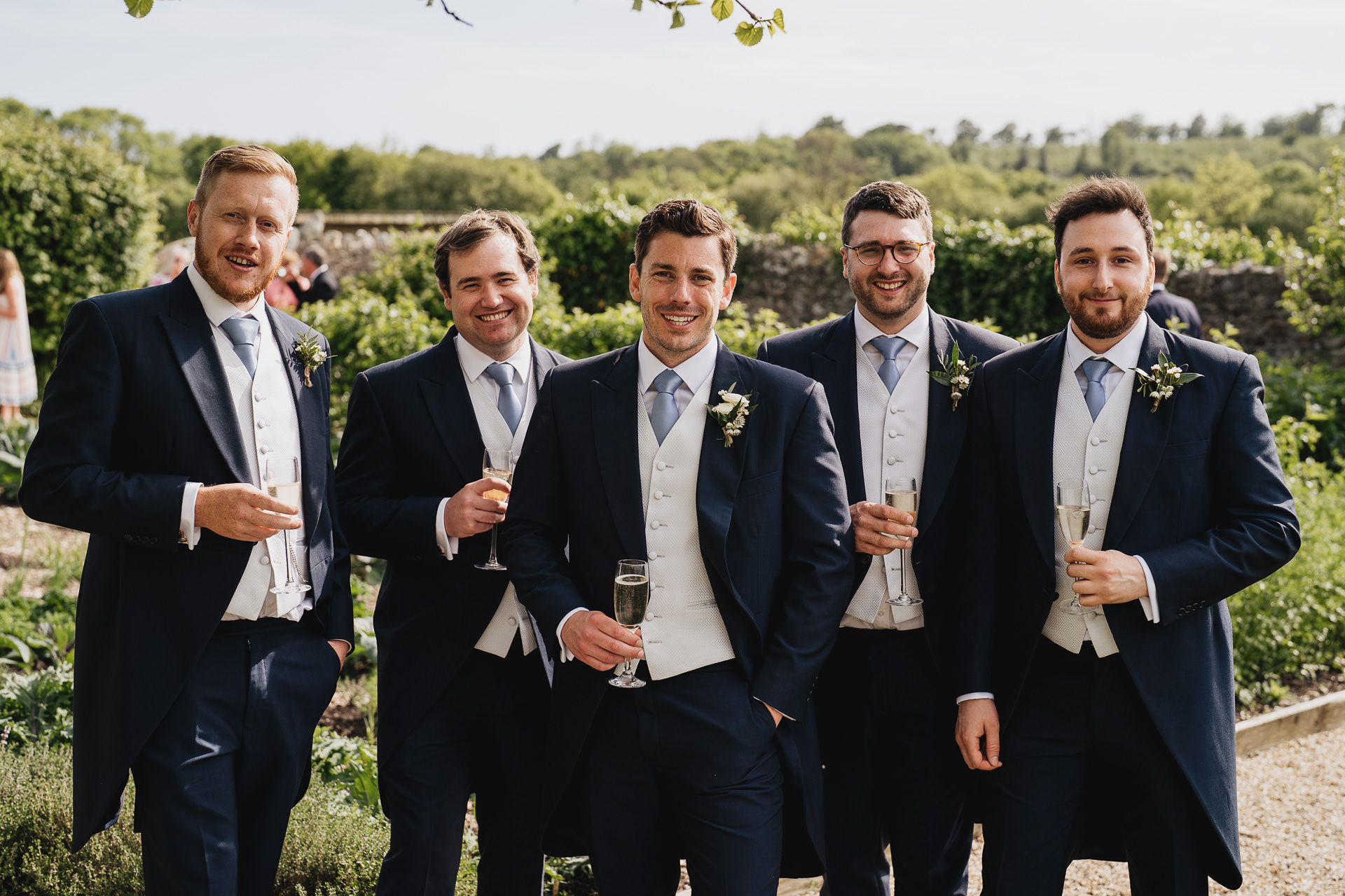 Groom and groomsmen in the kitchen garden at River Cottage