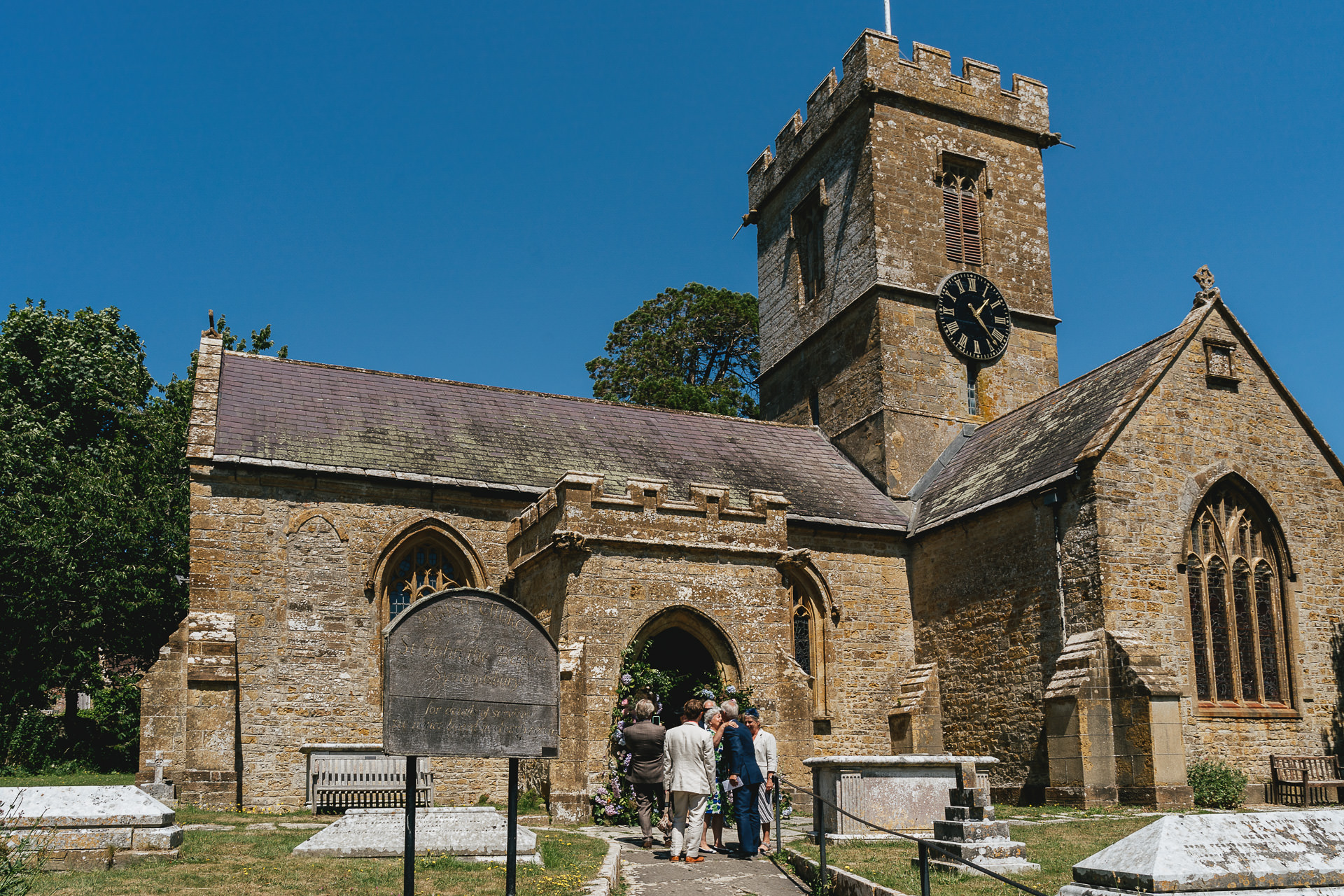 Guests arriving for a wedding at the church in Symondsbury, Dorset
