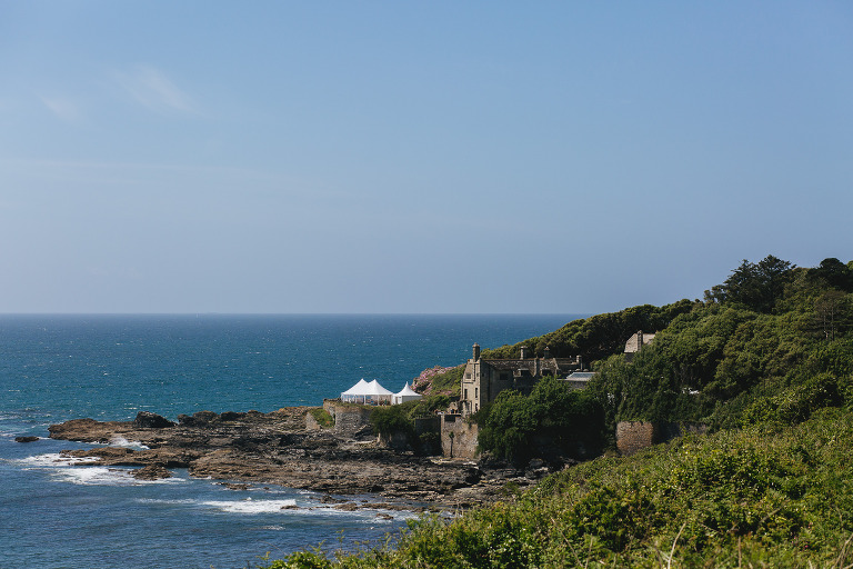 View of Porth en Alls at Prussia Cove, with a marquee set up on the peninsula ready for a wedding day