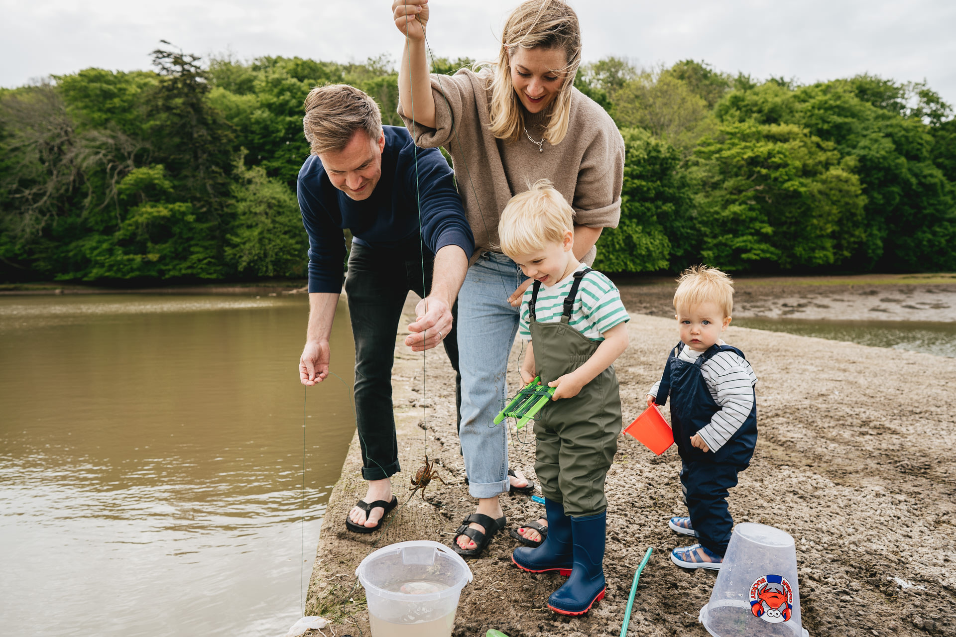 A family lifting crabs out of the River Dart together at Stoke Gifford in Devon