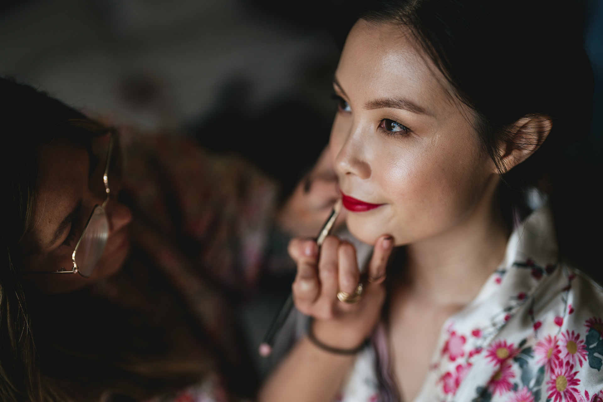 A woman having make up done in preparation for a Chinese wedding tea ceremony
