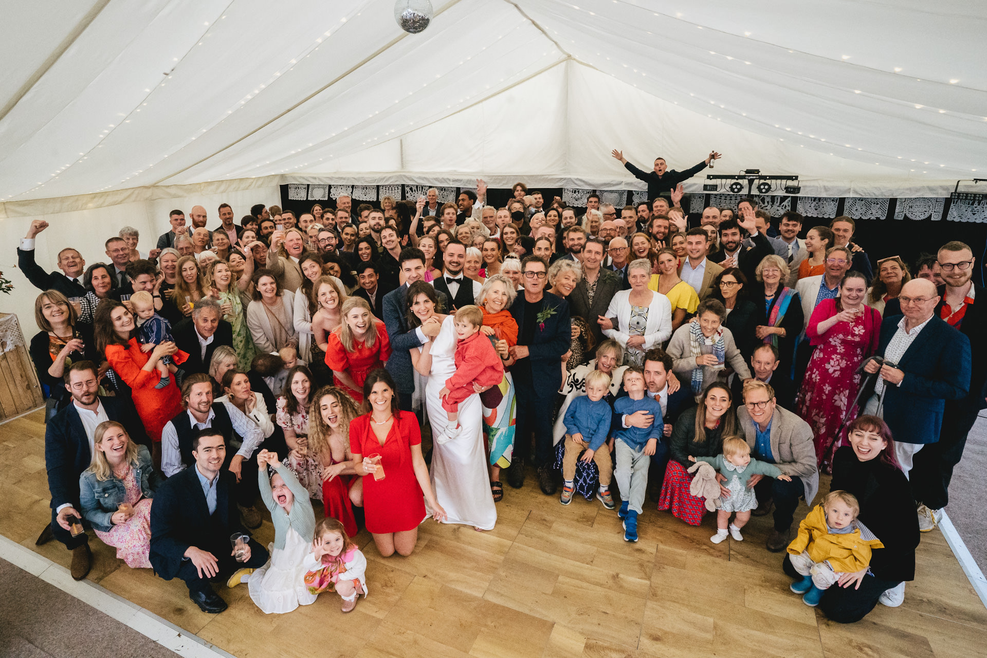 A large indoor group photo at a wedding on Dartmoor in a marquee