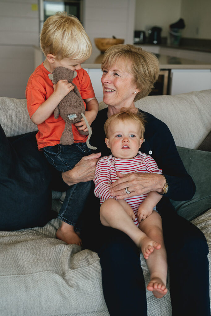 A grandmother playing with two young grandchildren