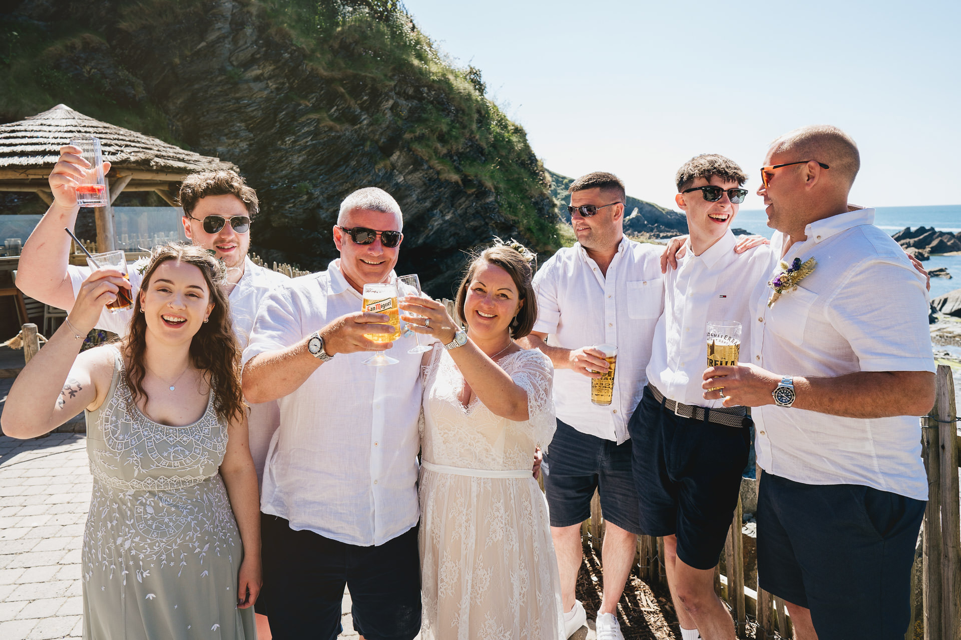 A relaxed wedding group photo at Tunnels Beaches