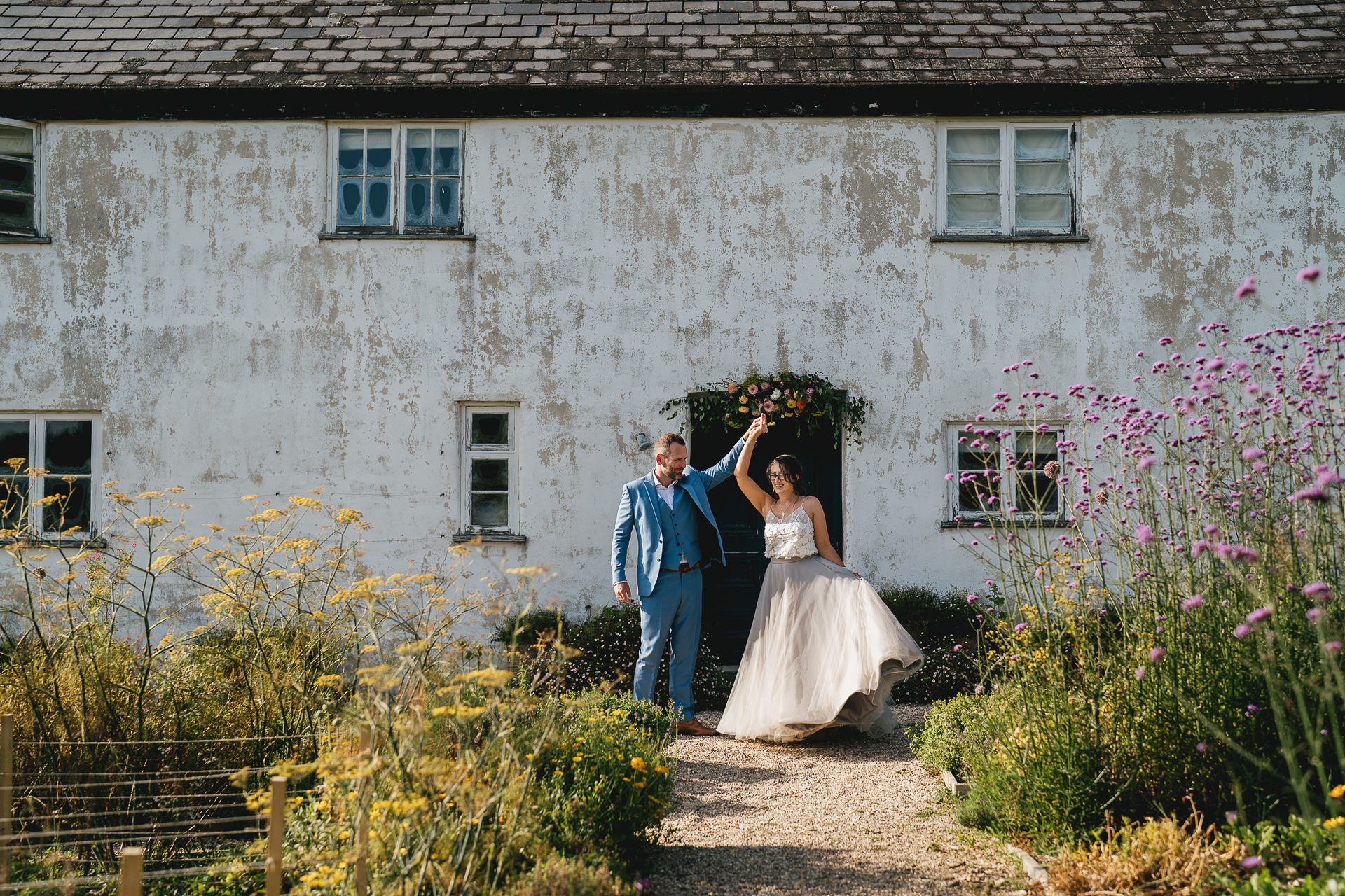 Bride and groom dancing outside the farmhouse at River Cottage