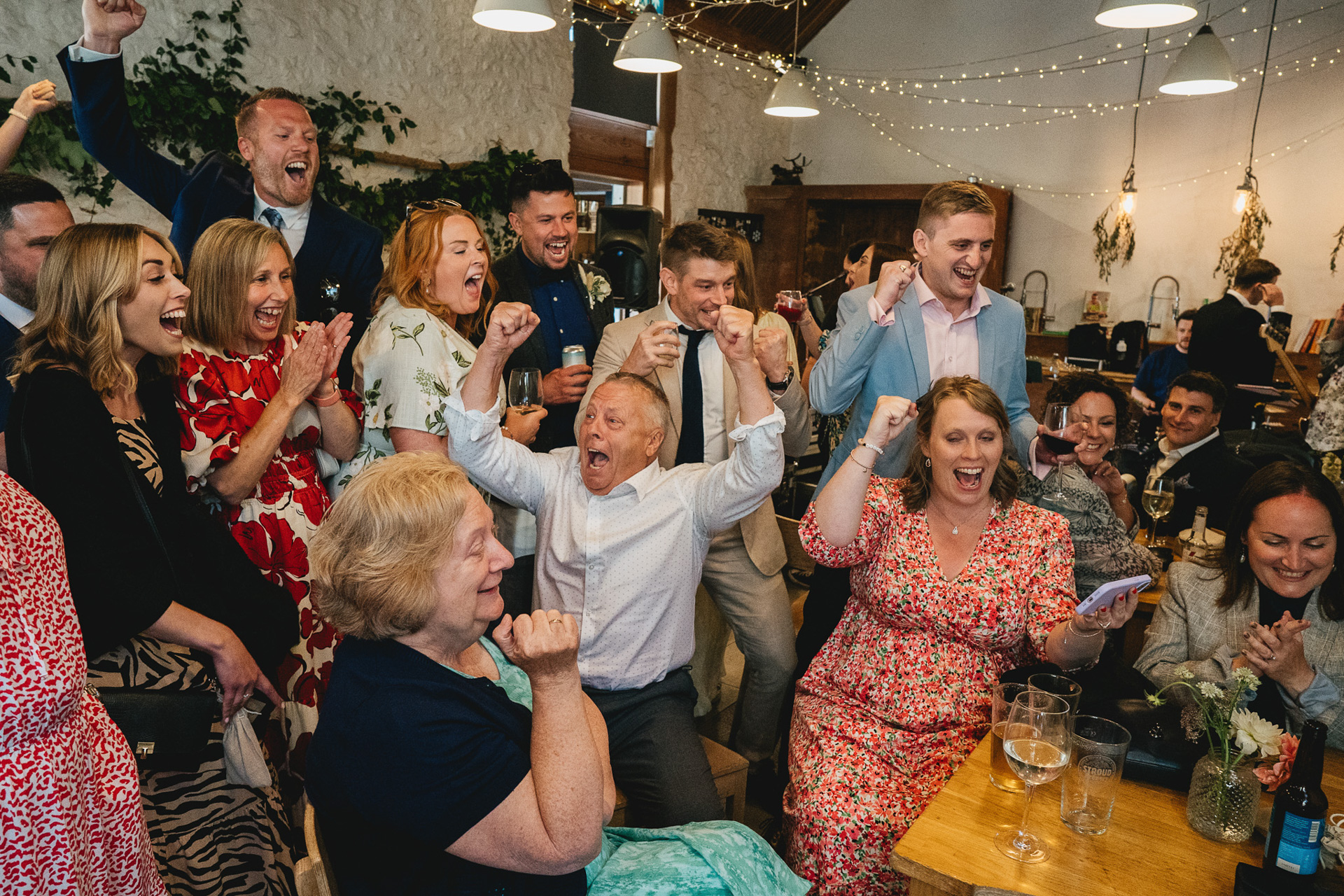 Wedding guests celebrating a goal during a penalty shoot out at a River Cottage wedding