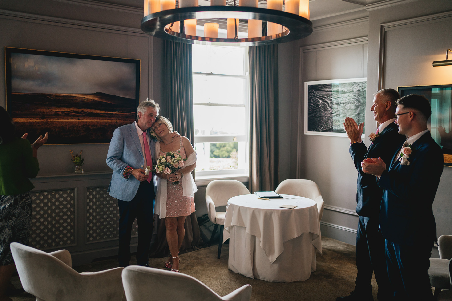 A tiny elopement ceremony at Lympstone Manor in Devon, with the best man and husband clapping the bride and groom