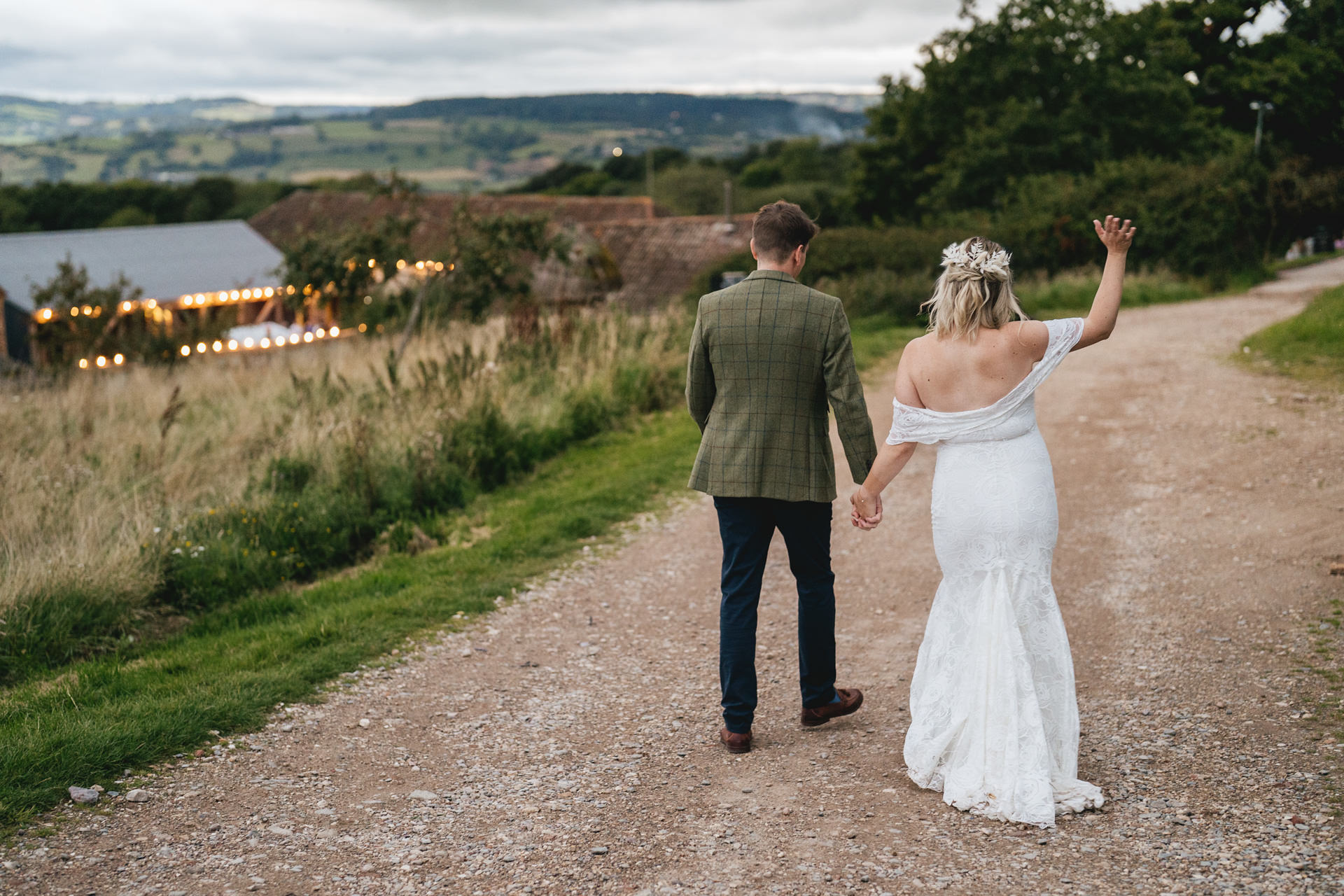 A bride and groom walking down the pathway at River Cottage in Devon on their wedding day