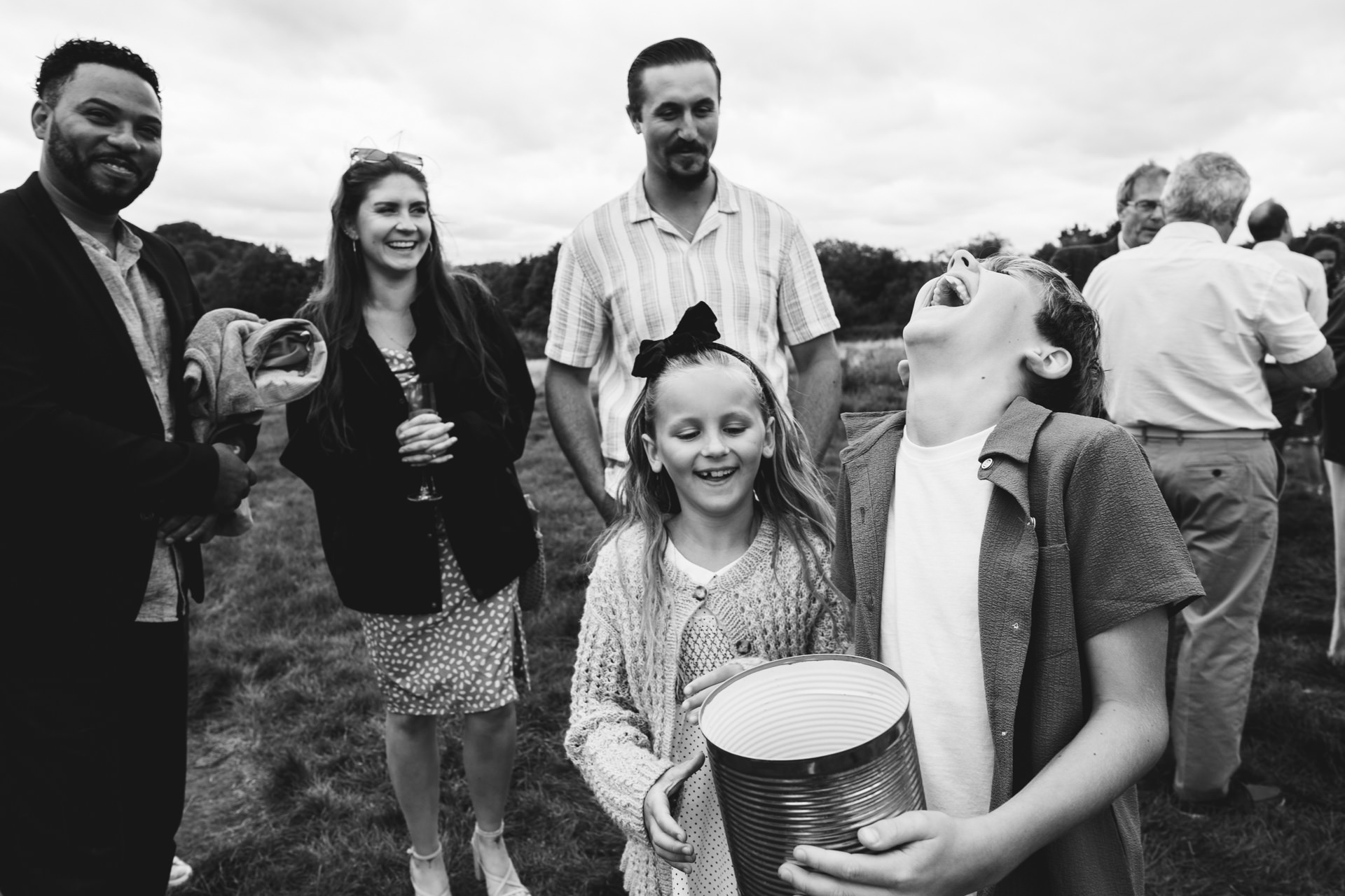 Wedding guests and children laughing at a River Cottage wedding