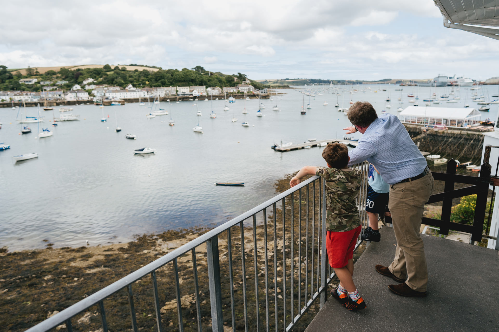 Wedding guests at a Cornwall wedding looking across the River Fal