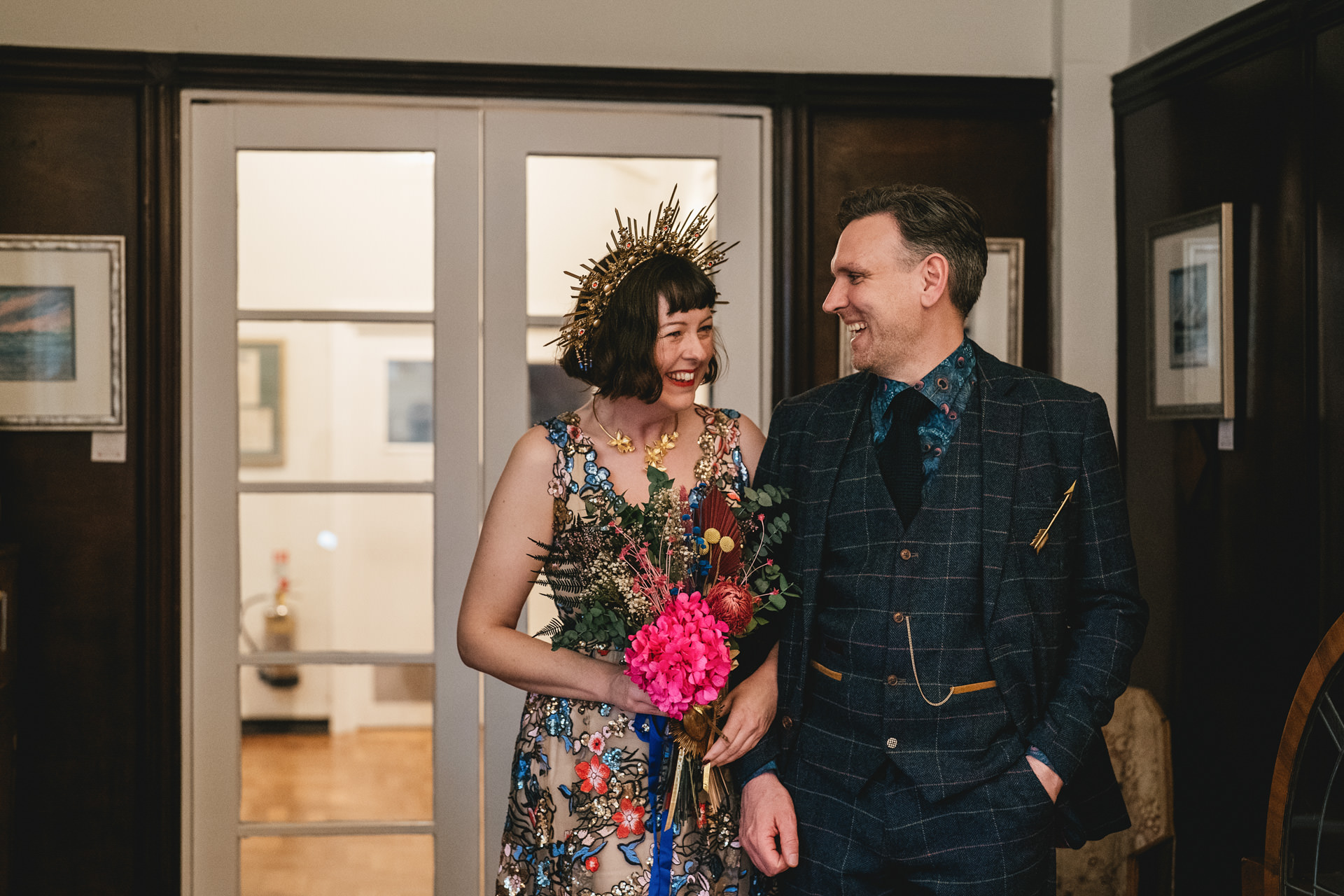 A bride and groom smiling at each other before their Burgh Island wedding 