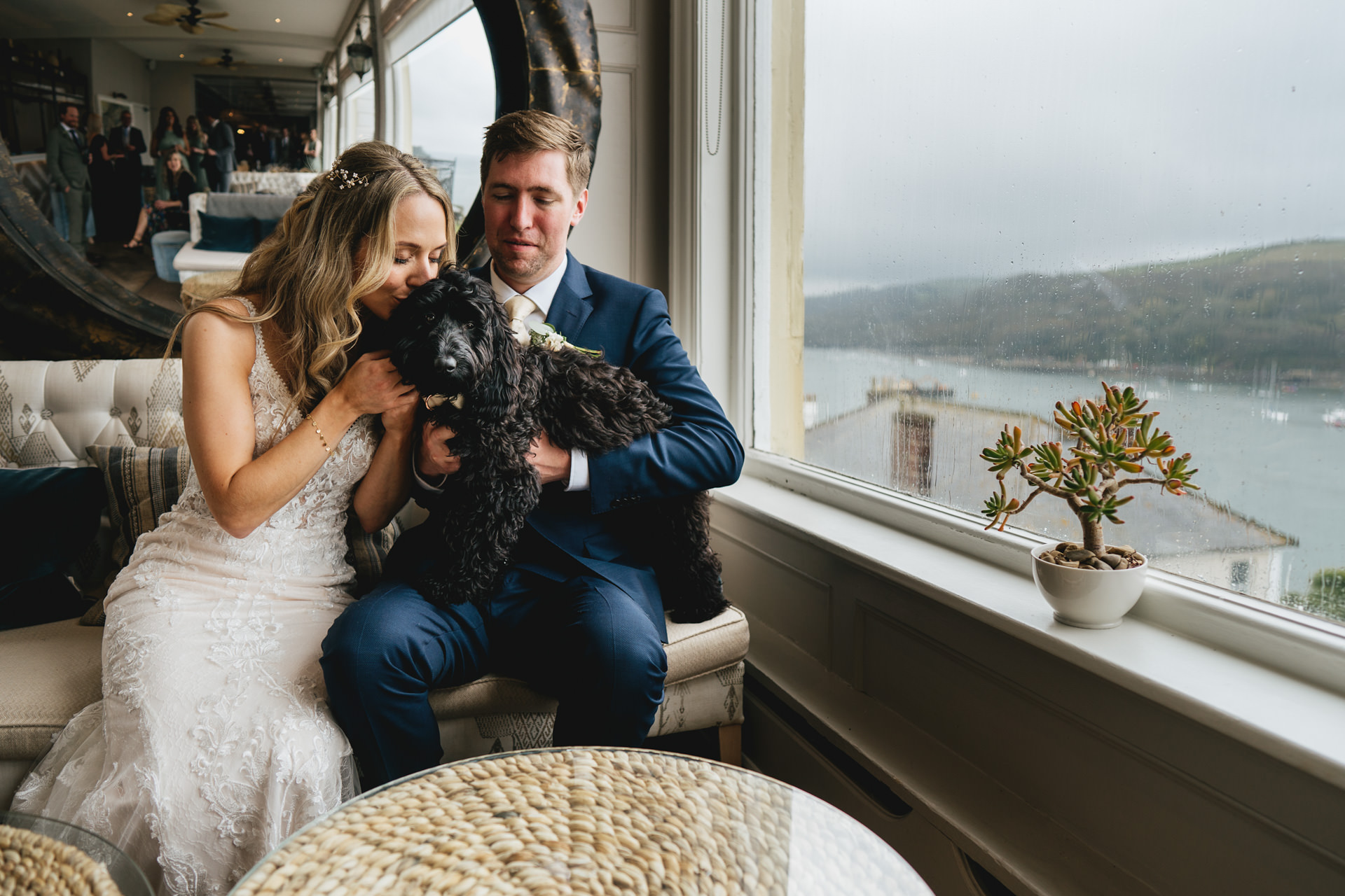 A bride and groom with their Cockerpoo dog at their wedding in Cornwall