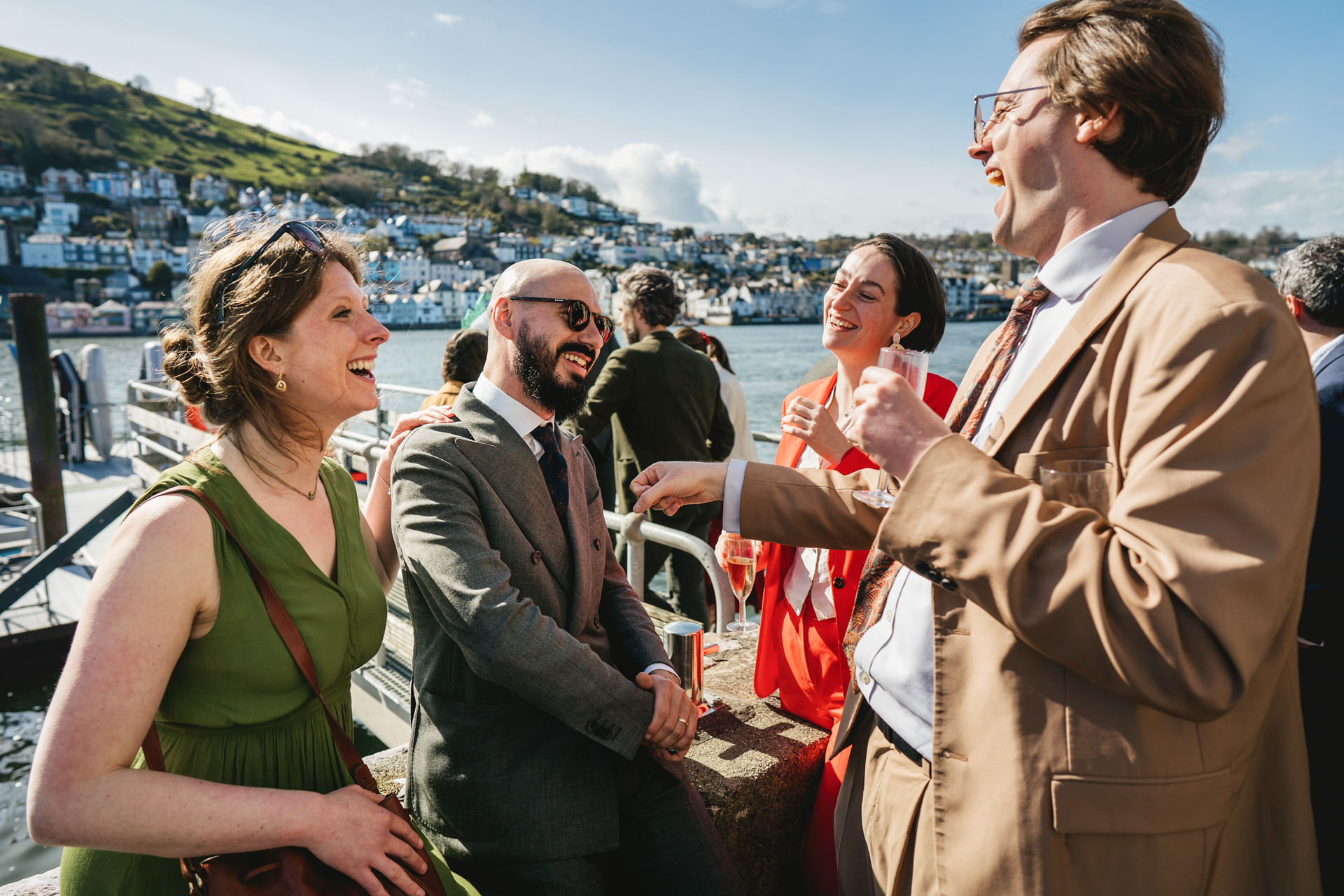 Wedding guests laughing by the River in South Devon