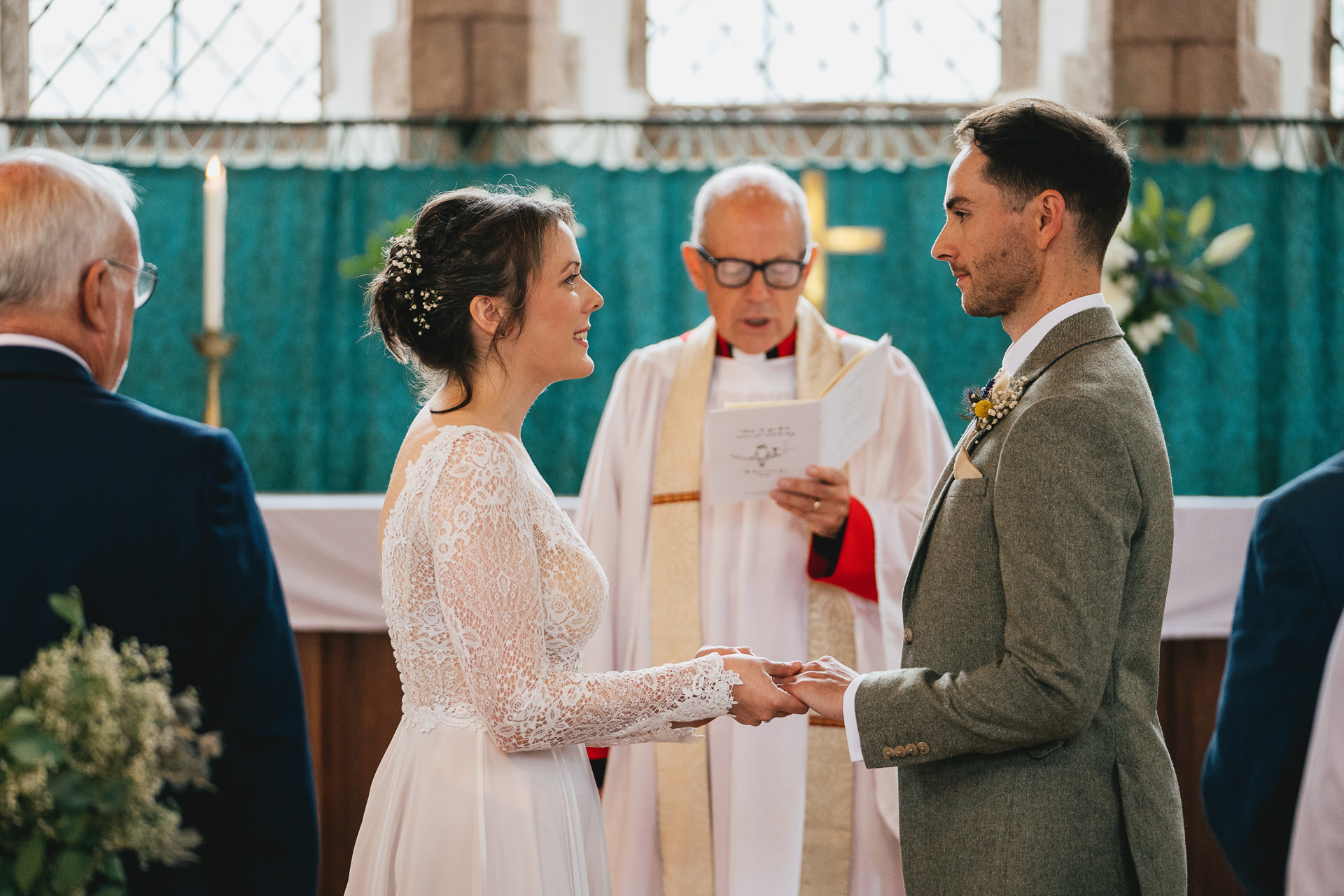 A couple saying their wedding vows at St Lawrence Chapel in Crediton Devon