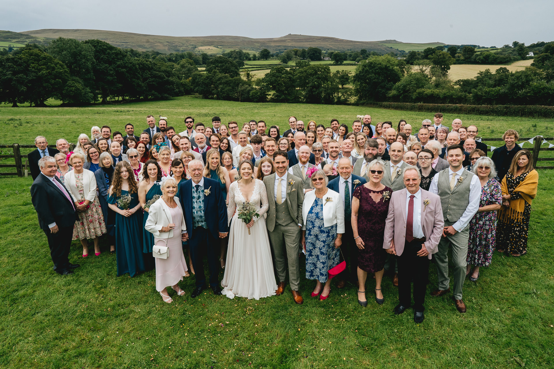 A large wedding group photo at a village hall on Dartmoor