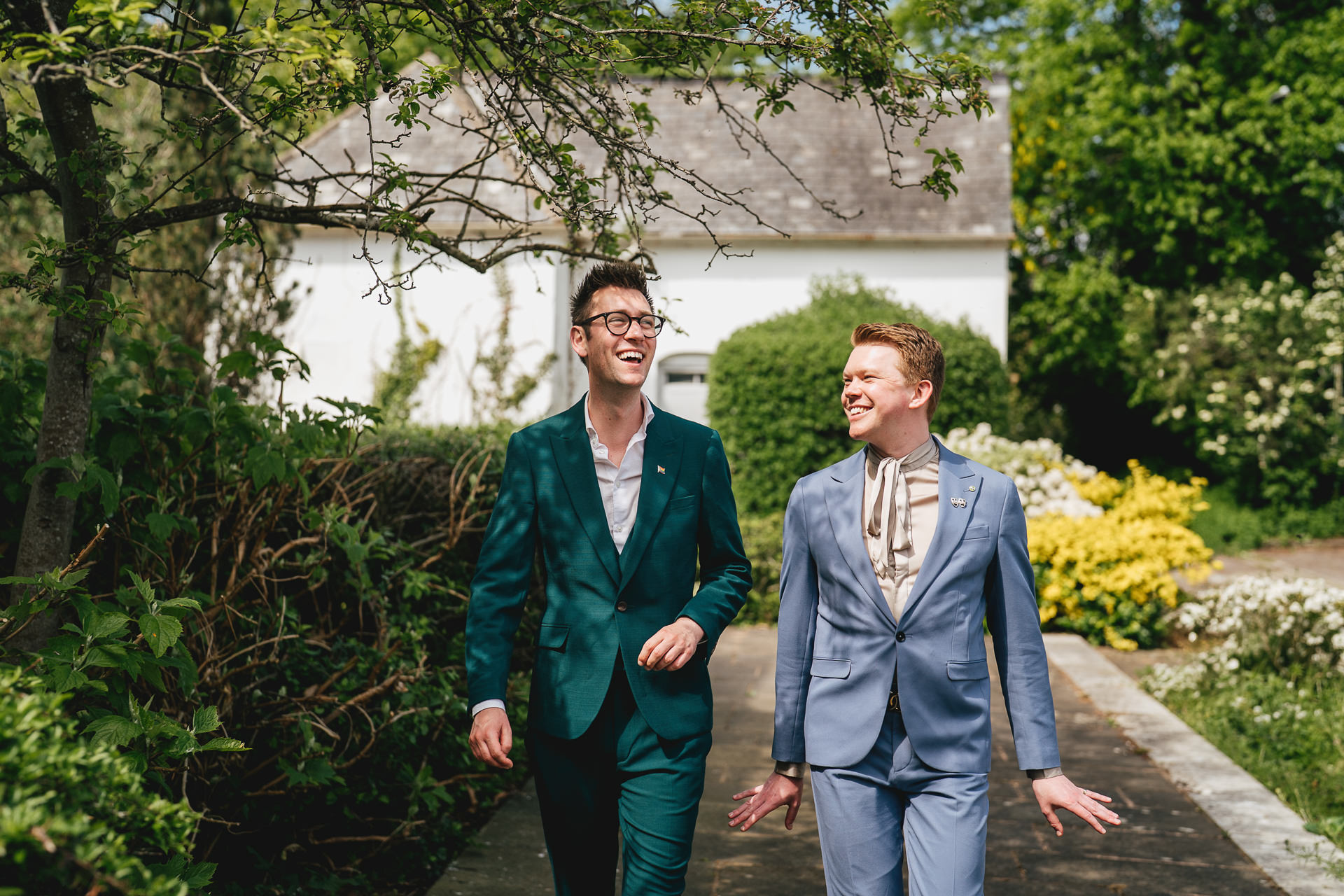 Grooms walking and smiling together after their elopement wedding in Exeter