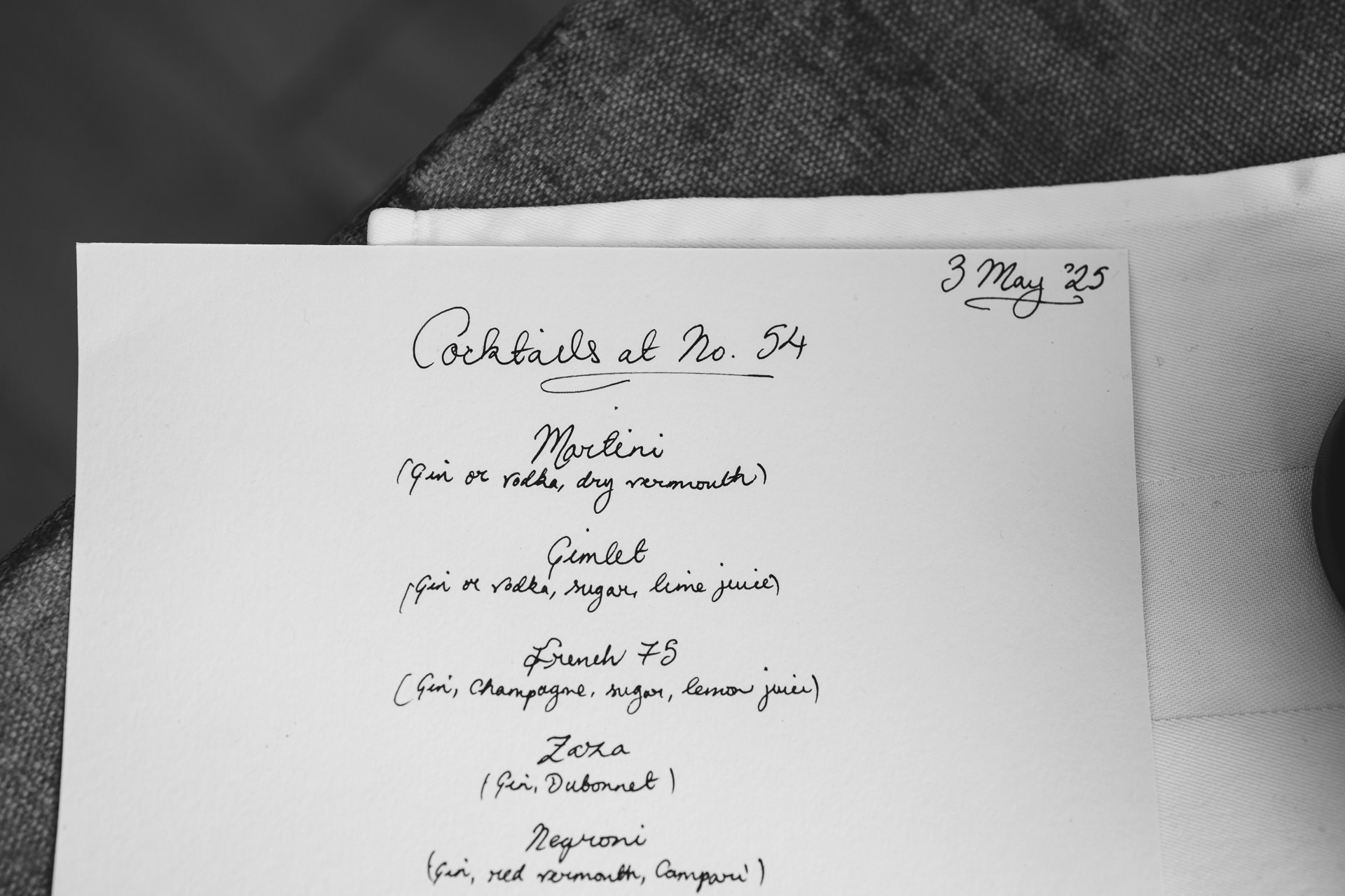 A cocktail menu handwritten in beautiful writing