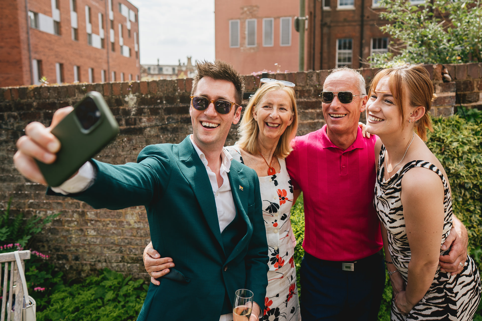 A family group taking a selfie together in the garden of Rendezvous Wine Bar in Exeter