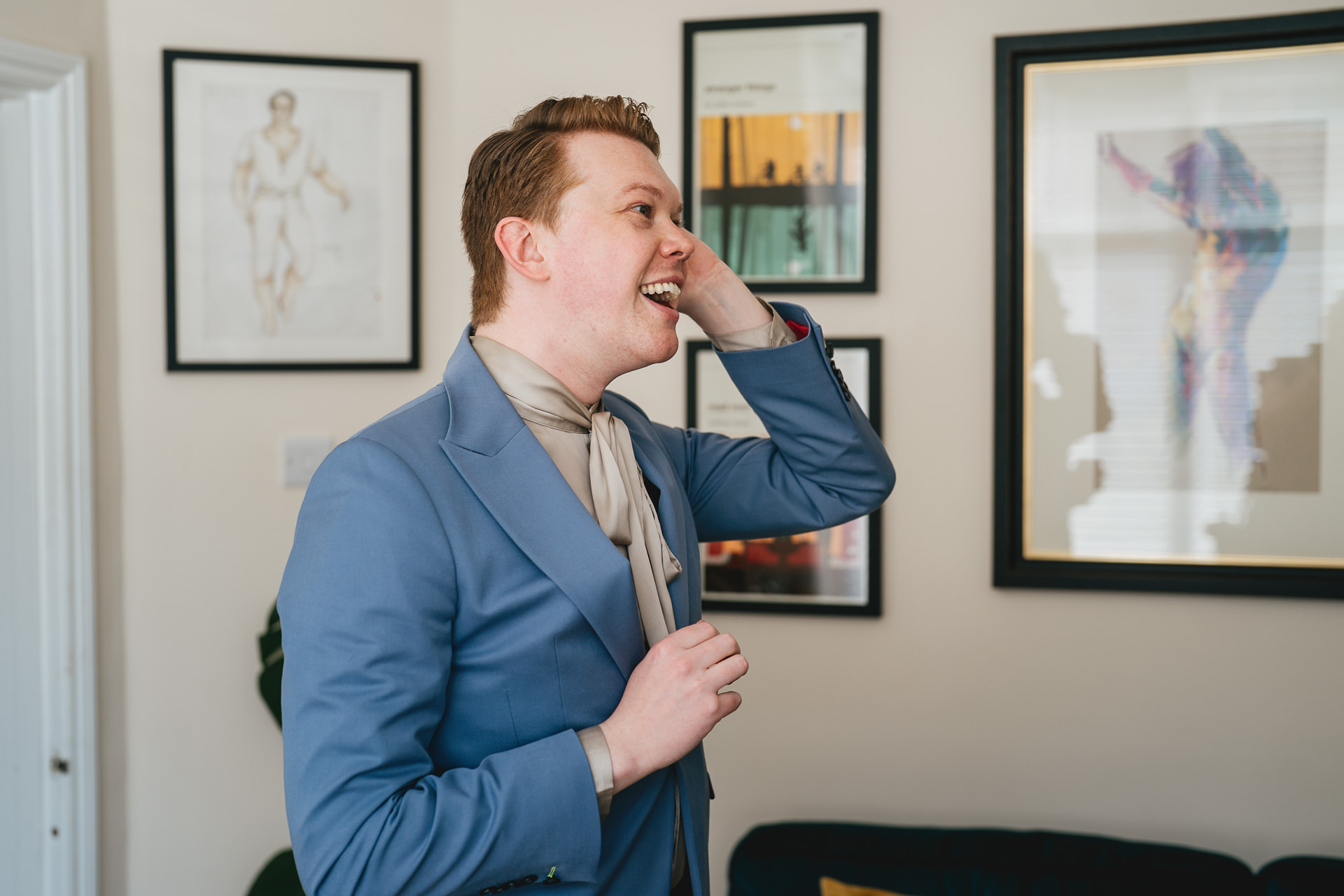 A groom getting dressed in his Exeter home, ready for his elopement wedding