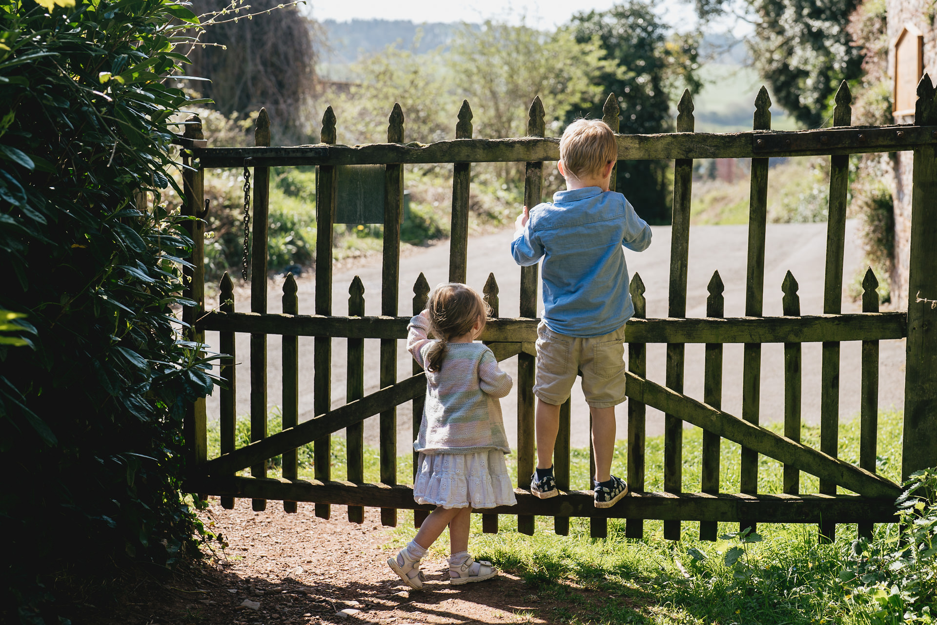 Two children by a gate at Newton St Cyres arboretum 