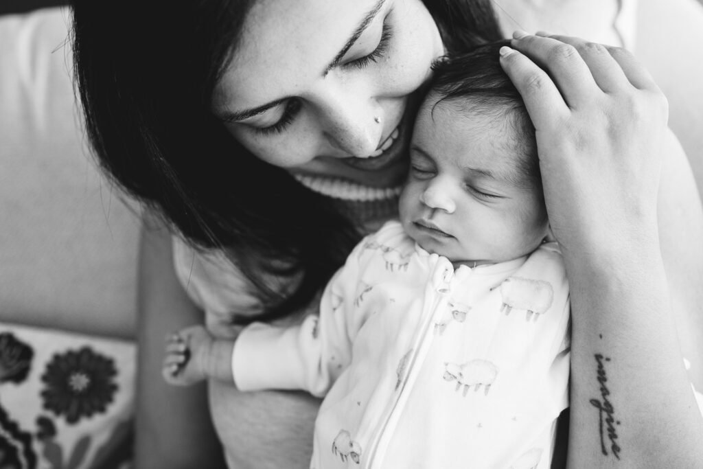 Newborn photography session images of a mother at home with her baby
