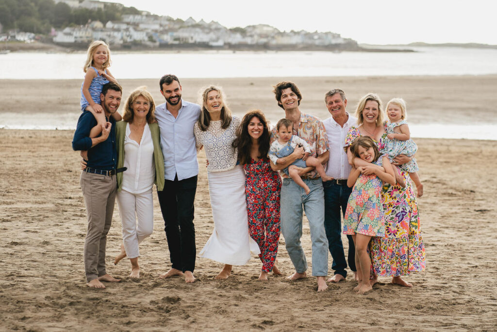 An extended family group photo on a beach in North Devon