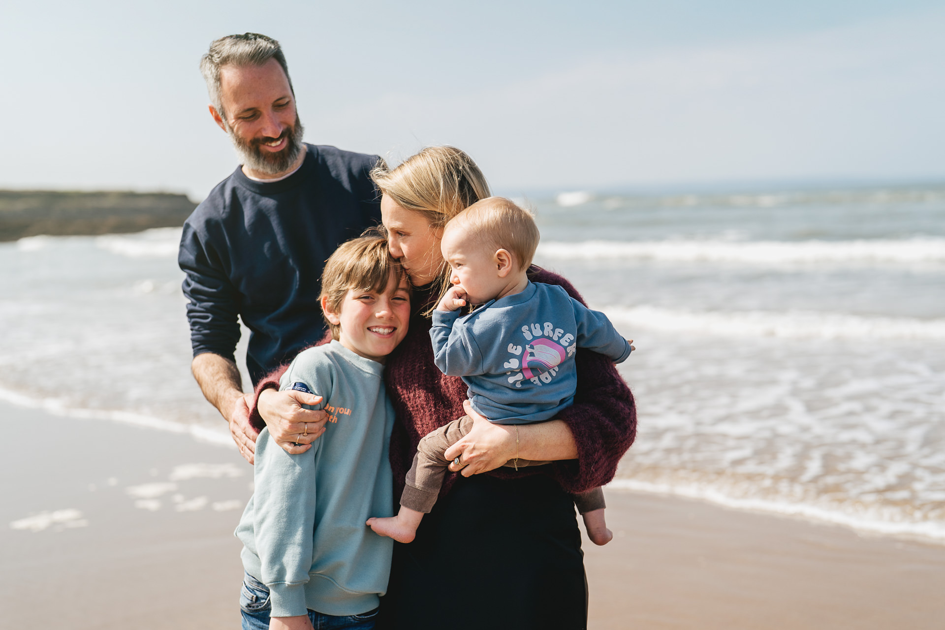 A family group on the beach together in Croyde