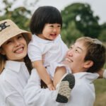Parents playing with a young toddler girl during a family photography session at the Newt in Somerset