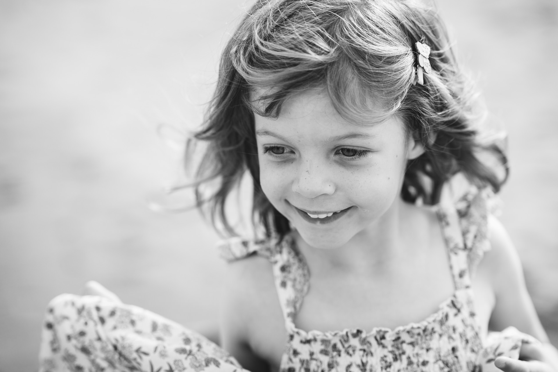 A young girl playing on the beach in Devon during a photography session