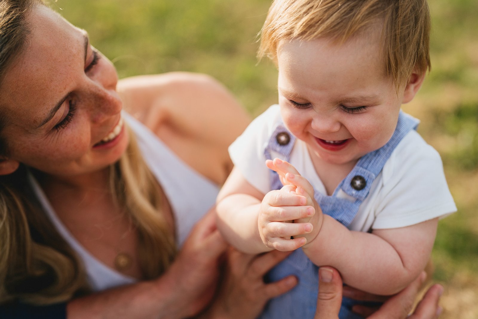 A mother and her young son smiling together during a family photo session in Torbay